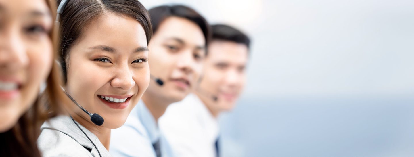 Smiling,Cheerful,Asian,Woman,Working,In,Call,Center,Office,With